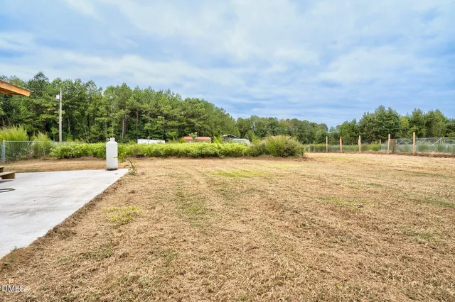 a view of backyard of house with outdoor seating
