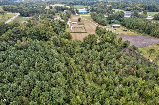 a aerial view of a house with swimming pool and lake view