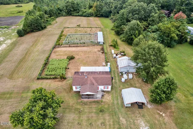 an aerial view of a house with yard swimming pool and mountain view