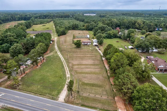an aerial view of a house with swimming pool and garden
