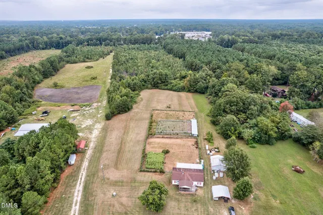 an aerial view of a house with outdoor space
