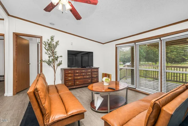 a living room with furniture a fireplace and a flat screen tv