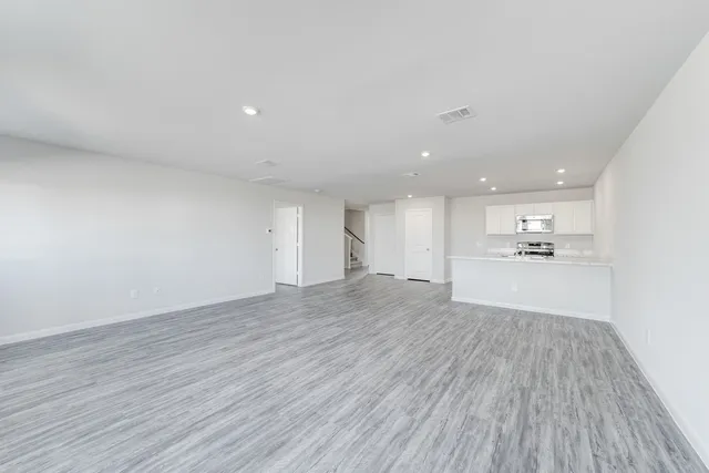 a view of a kitchen with wooden floor and kitchen