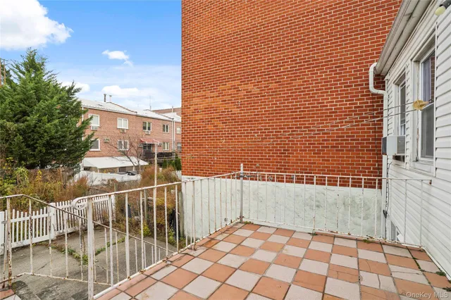a view of a brick wall next to a brick building