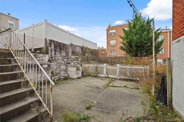 a view of a large building with wooden fence