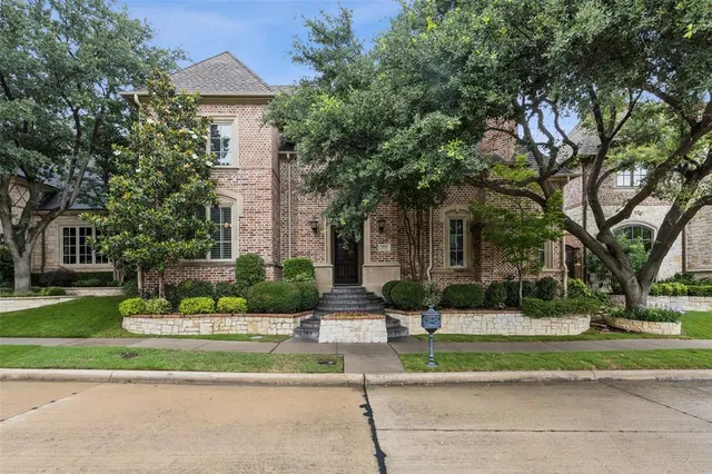 a front view of a house with a yard and plants