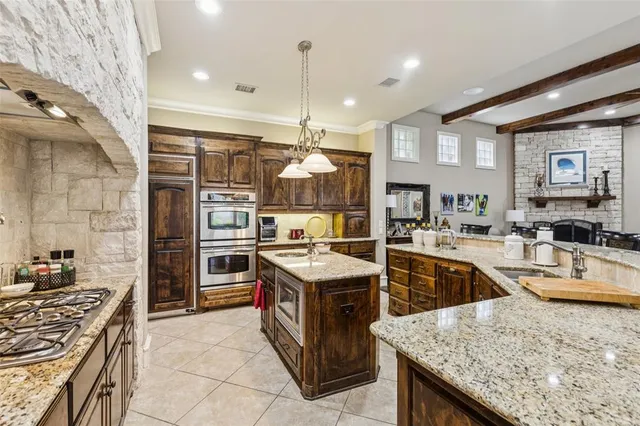 a kitchen with stainless steel appliances granite countertop a stove and a sink
