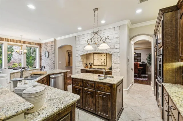 a kitchen with a stove kitchen island furniture and a view of living room