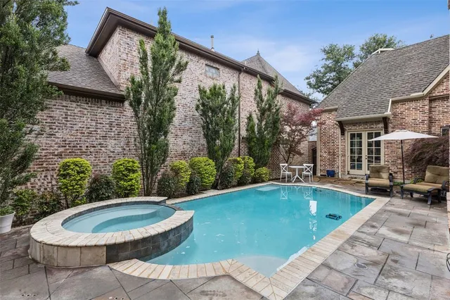a view of a house with swimming pool and sitting area