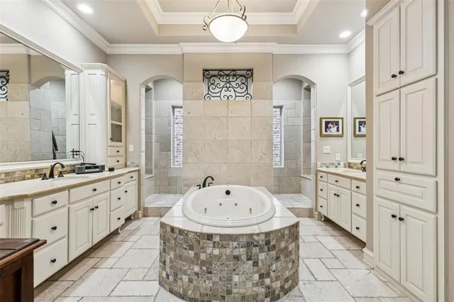 a spacious bathroom with double vanity a mirror a vanity and a bathtub