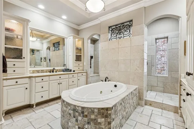 a bathroom with a tub sink and mirror