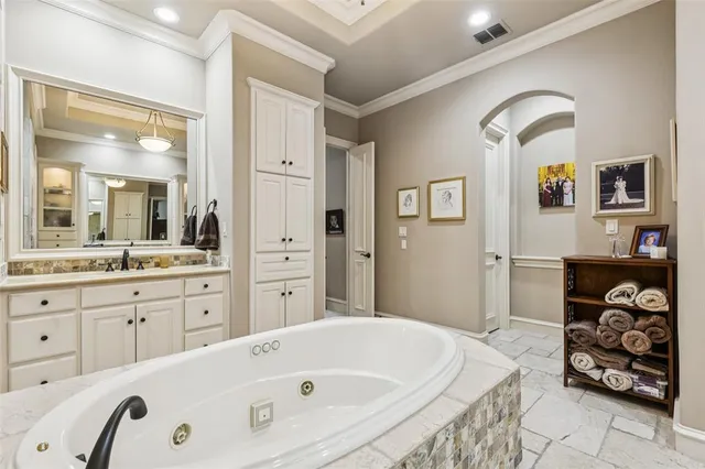 a bathroom with a tub sink and mirror