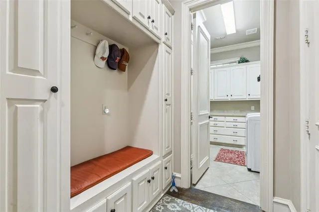 a kitchen with white cabinets and sink