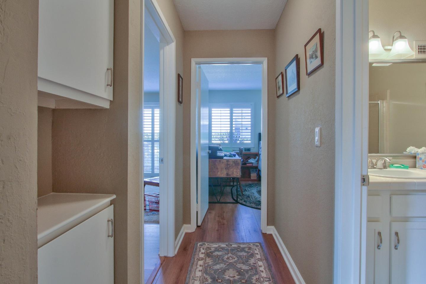 4000 Rio Road, Unit 26 Carmel, CA 93923 - Photo 12 of 27 a view of a hallway with wooden floor and a bathroom