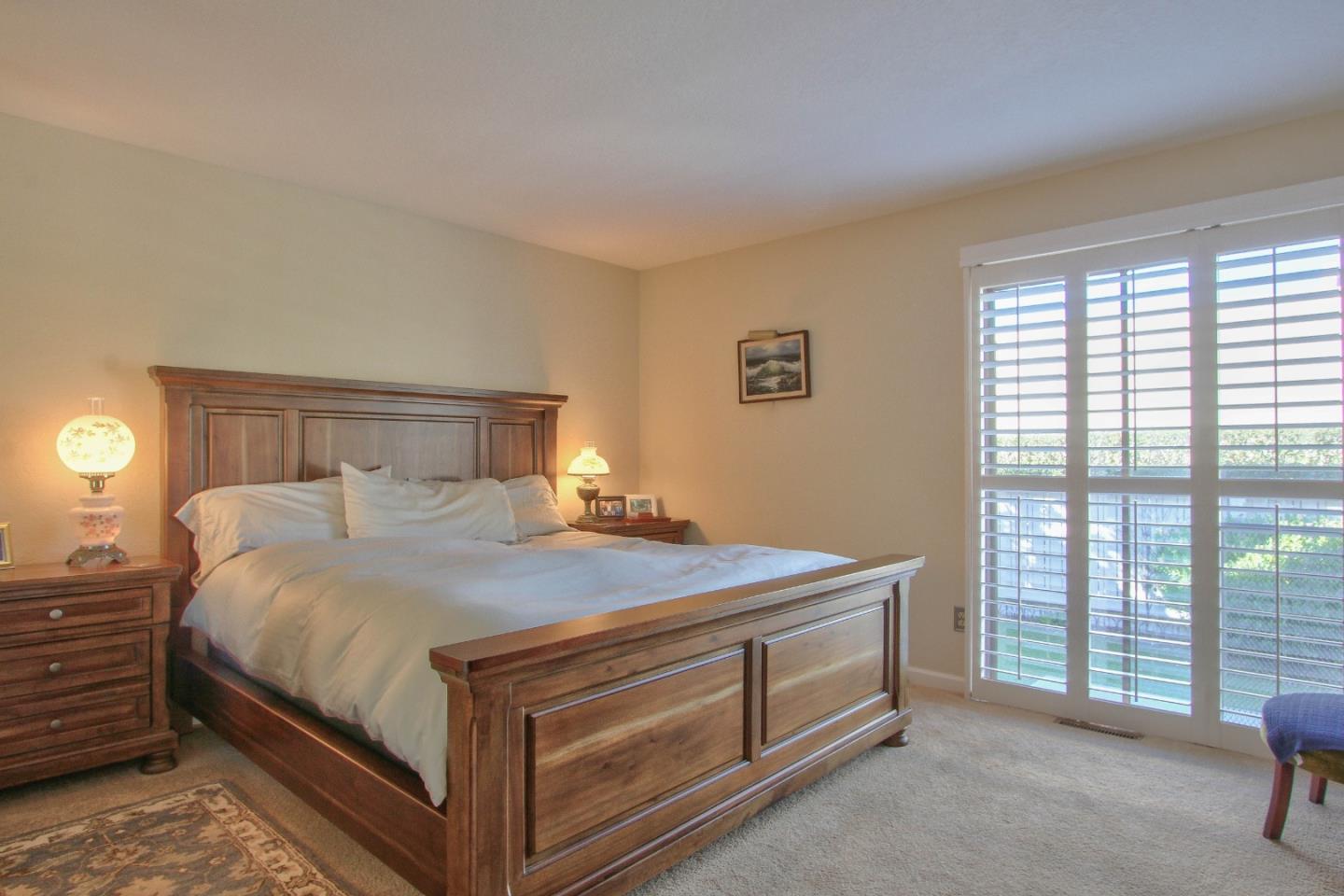 4000 Rio Road, Unit 26 Carmel, CA 93923 - Photo 13 of 27 a bedroom with a bed and a window