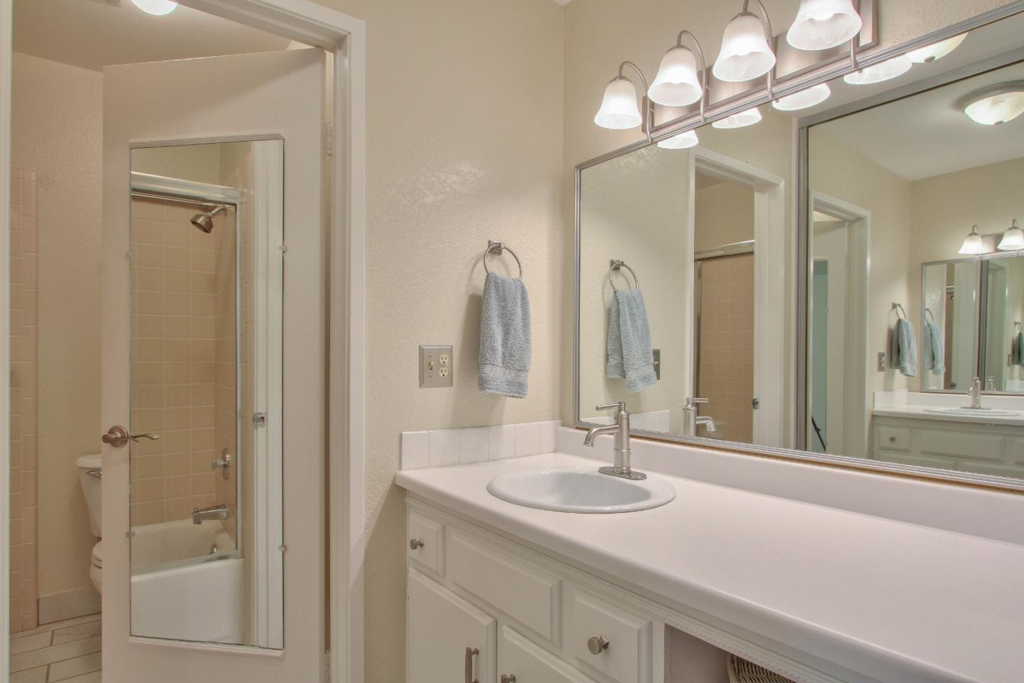 4000 Rio Road, Unit 26 Carmel, CA 93923 - Photo 15 of 27 a bathroom with a sink a light fixture and a mirror
