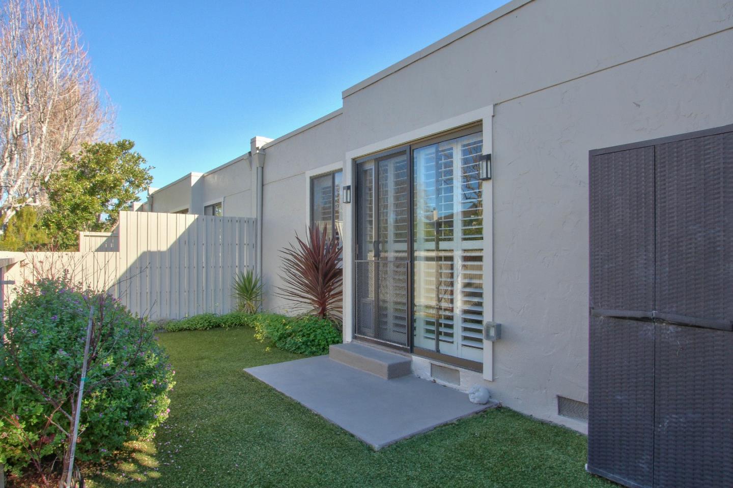 4000 Rio Road, Unit 26 Carmel, CA 93923 - Photo 23 of 27 a view of backyard with potted plants and wooden fence
