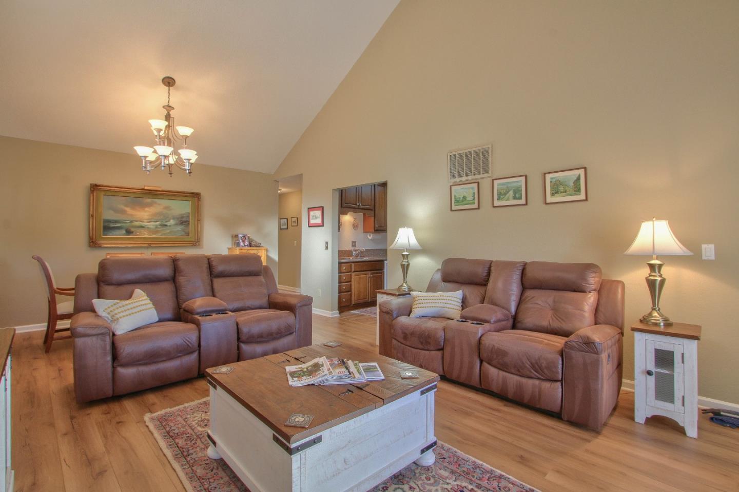 4000 Rio Road, Unit 26 Carmel, CA 93923 - Photo 6 of 27 a living room with furniture a lamp and a chandelier