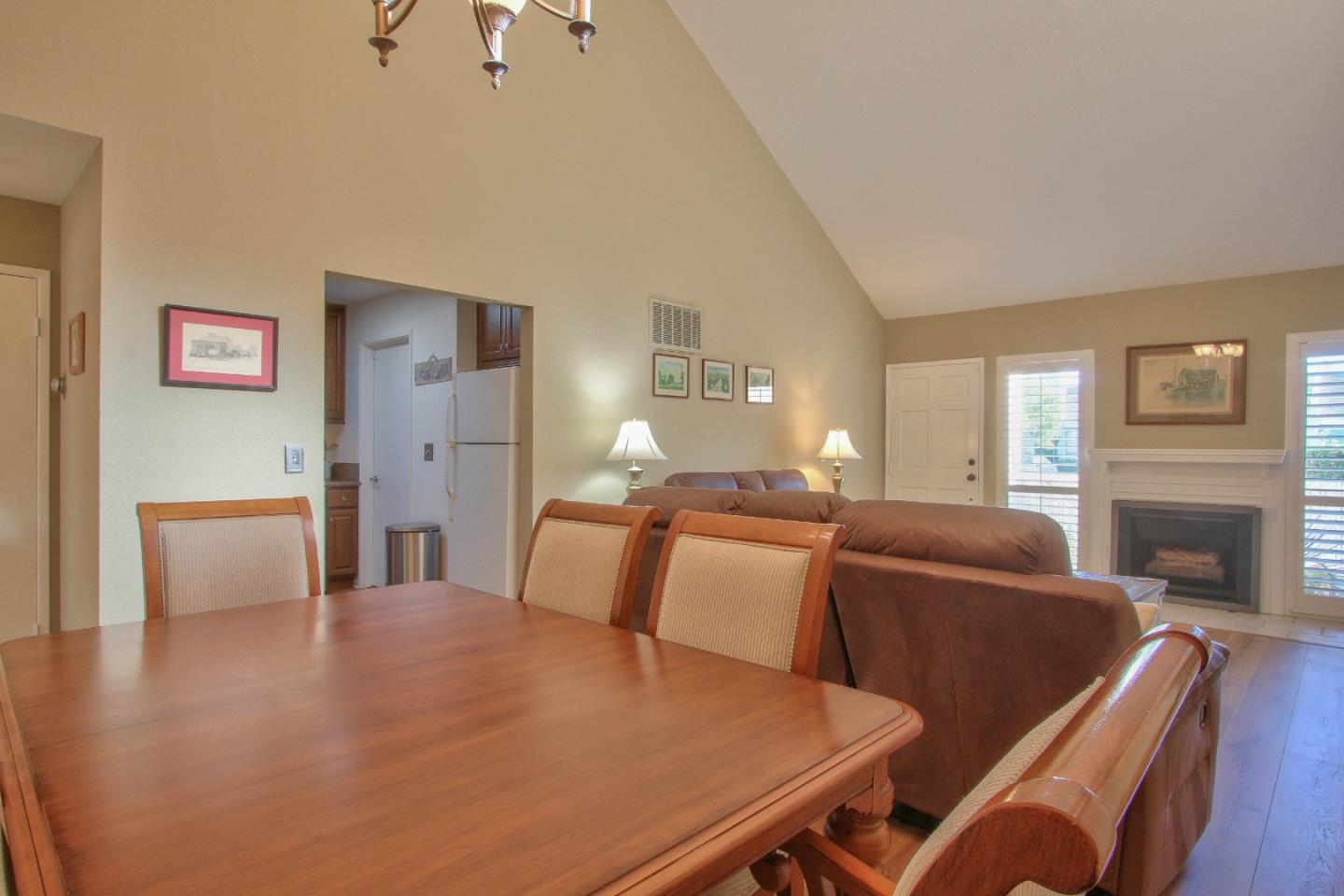 4000 Rio Road, Unit 26 Carmel, CA 93923 - Photo 8 of 27 a living room with furniture a fireplace and a flat screen tv