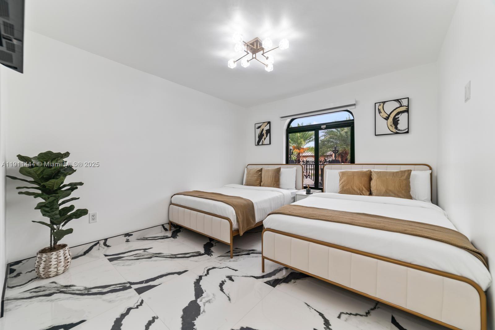 14242 Southwest 30th Street Miami, FL 33175 - Photo 16 of 45 a bedroom with two beds and a potted plant