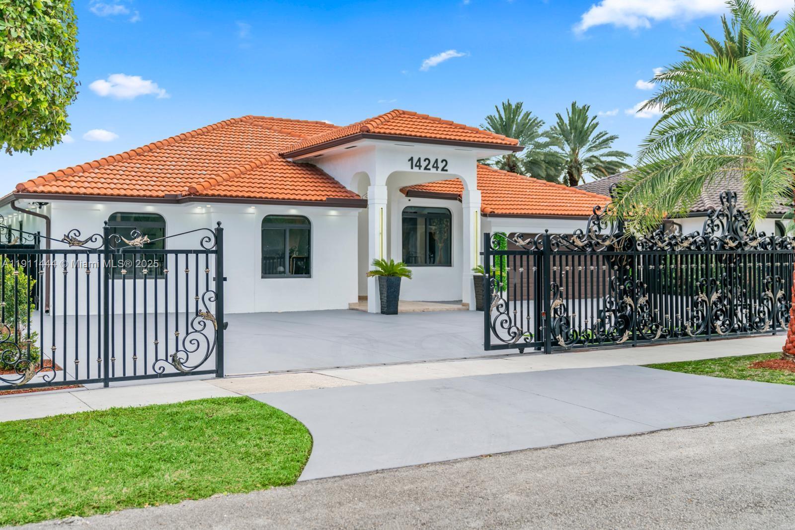 14242 Southwest 30th Street Miami, FL 33175 - Photo 3 of 45 a front view of a house with garden