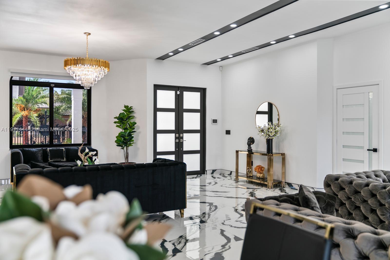 14242 Southwest 30th Street Miami, FL 33175 - Photo 4 of 45 a living room with lots of furniture and a chandelier