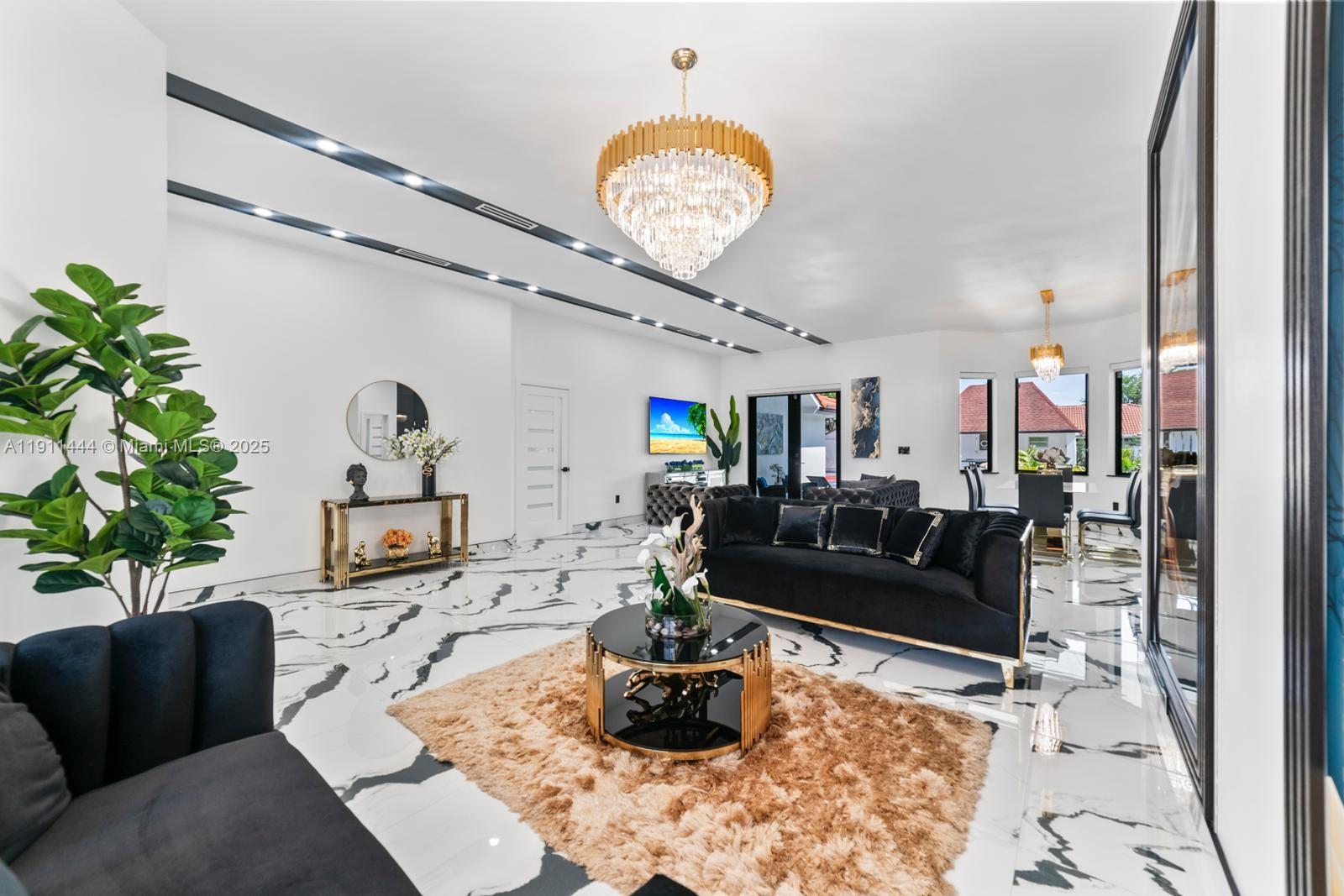 14242 Southwest 30th Street Miami, FL 33175 - Photo 8 of 45 a living room with furniture and a chandelier
