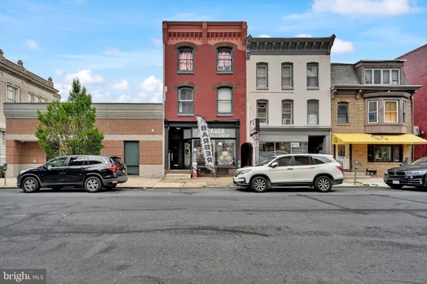 a car parked in front of a big building