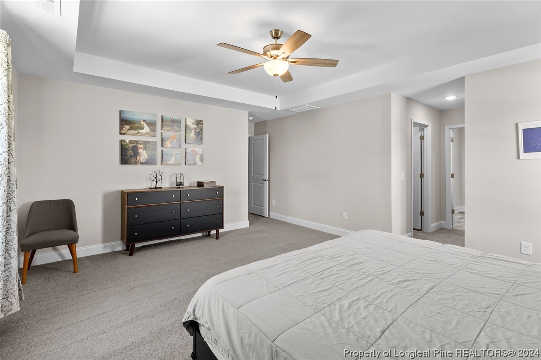 740 Walker Road Bunnlevel, NC 28323 - Photo 17 of 27 a bedroom with a bed and a chair