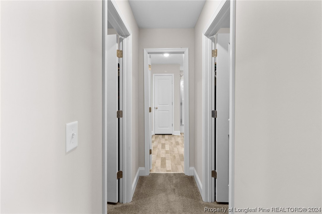 740 Walker Road Bunnlevel, NC 28323 - Photo 18 of 27 a view of a hallway with three rooms
