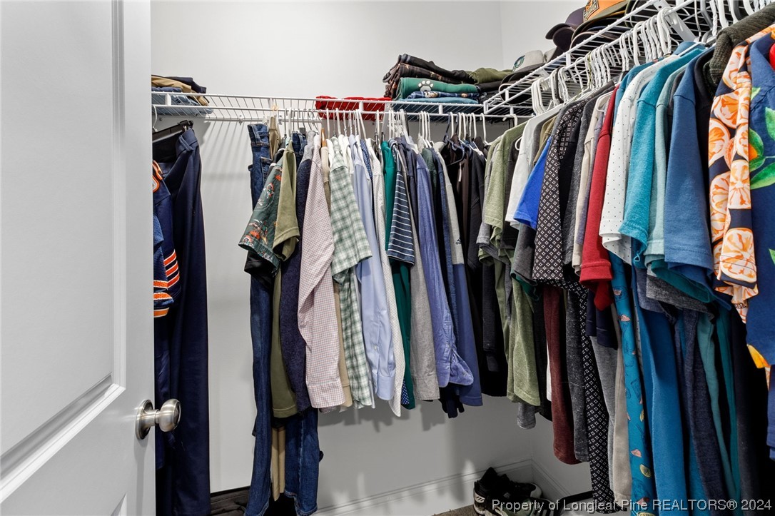 740 Walker Road Bunnlevel, NC 28323 - Photo 19 of 27 a view of walk in closet with clothes and shoes