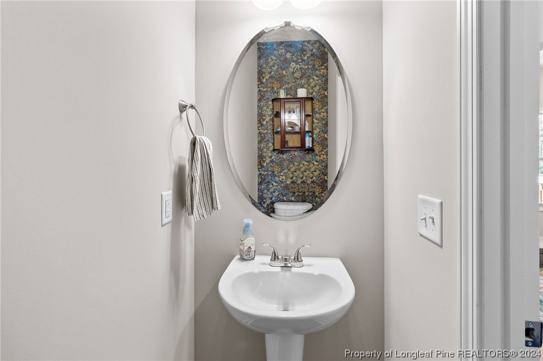 740 Walker Road Bunnlevel, NC 28323 - Photo 4 of 27 a bathroom with a sink and a mirror