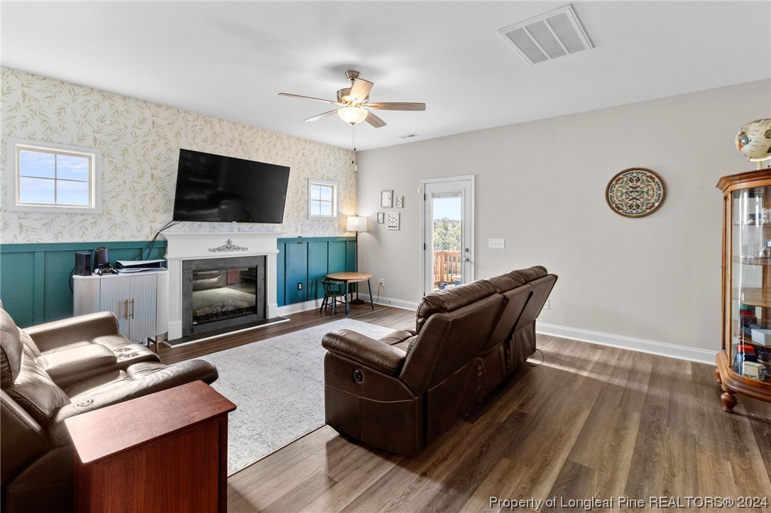 740 Walker Road Bunnlevel, NC 28323 - Photo 5 of 27 a living room with furniture a flat screen tv and a fireplace