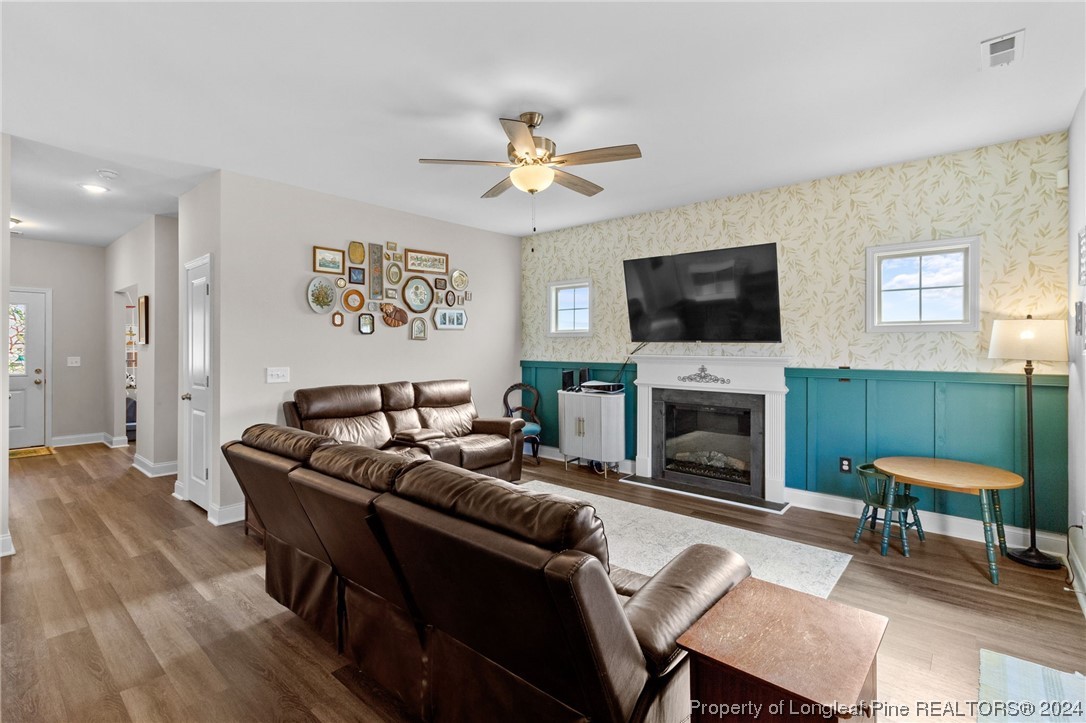 740 Walker Road Bunnlevel, NC 28323 - Photo 6 of 27 a living room with furniture a fireplace and a flat screen tv