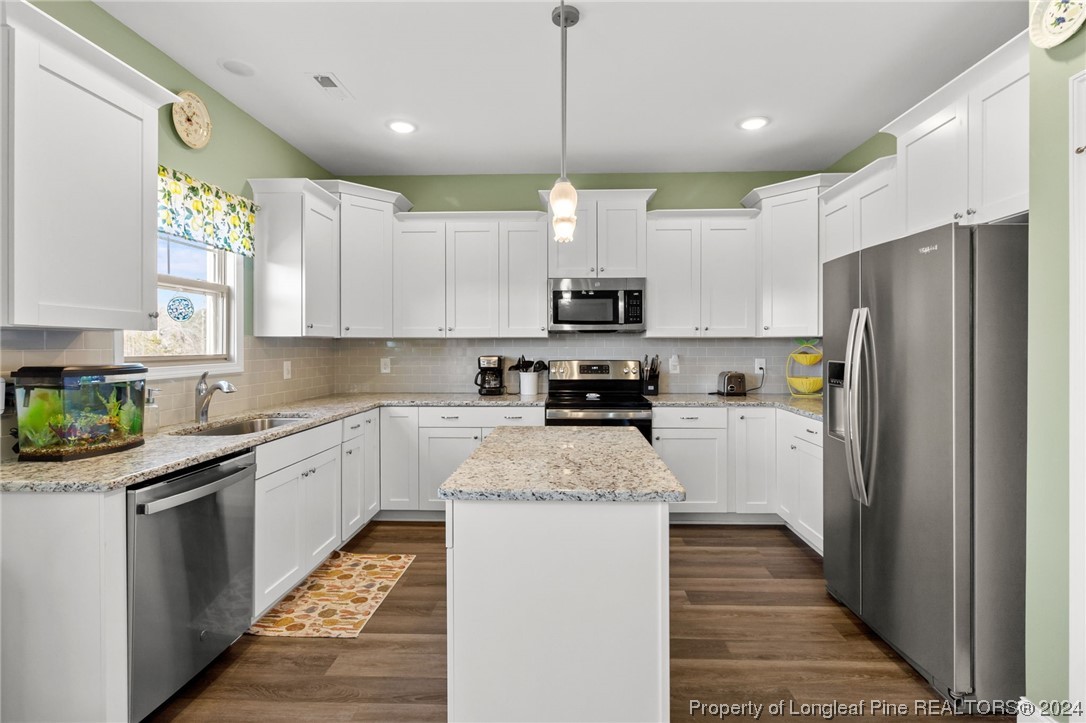 740 Walker Road Bunnlevel, NC 28323 - Photo 7 of 27 a kitchen with stainless steel appliances granite countertop a refrigerator a stove top oven a sink and dishwasher