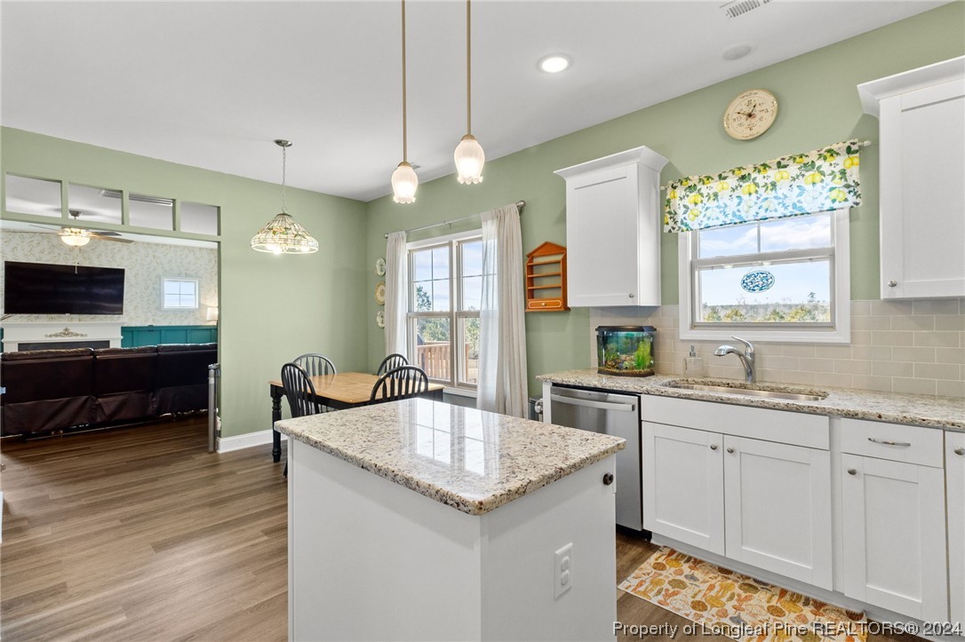 740 Walker Road Bunnlevel, NC 28323 - Photo 10 of 27 a kitchen with granite countertop a sink and cabinets