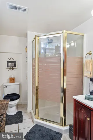 a bathroom with a double vanity sink mirror and toilet