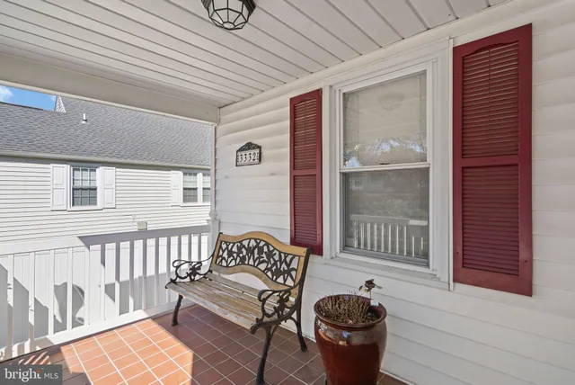 a balcony with furniture and a potted plant