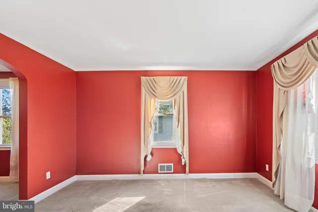 a view of a livingroom with wooden floor and a chandelier