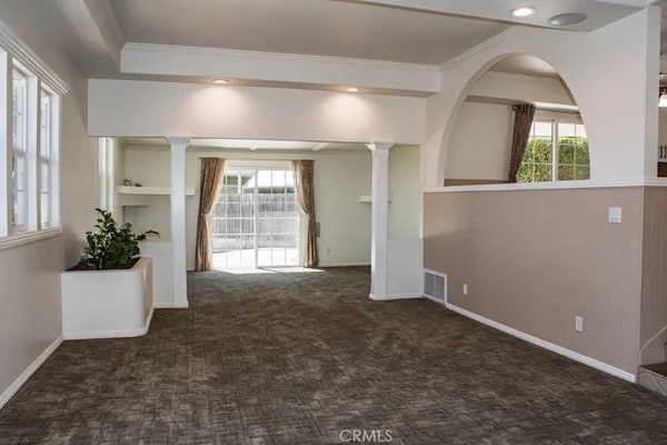 a kitchen with granite countertop white cabinets appliances and a counter space