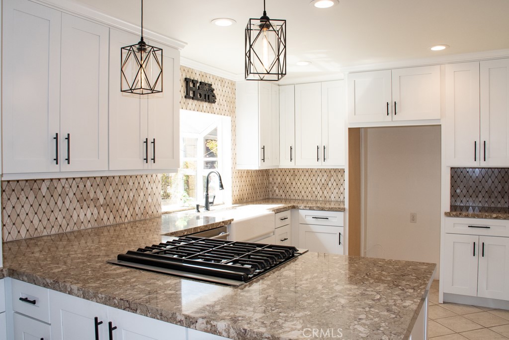 933 Eastside Road El Cajon, CA 92020 - Photo 20 of 70 a kitchen with kitchen island granite countertop a sink and a stove