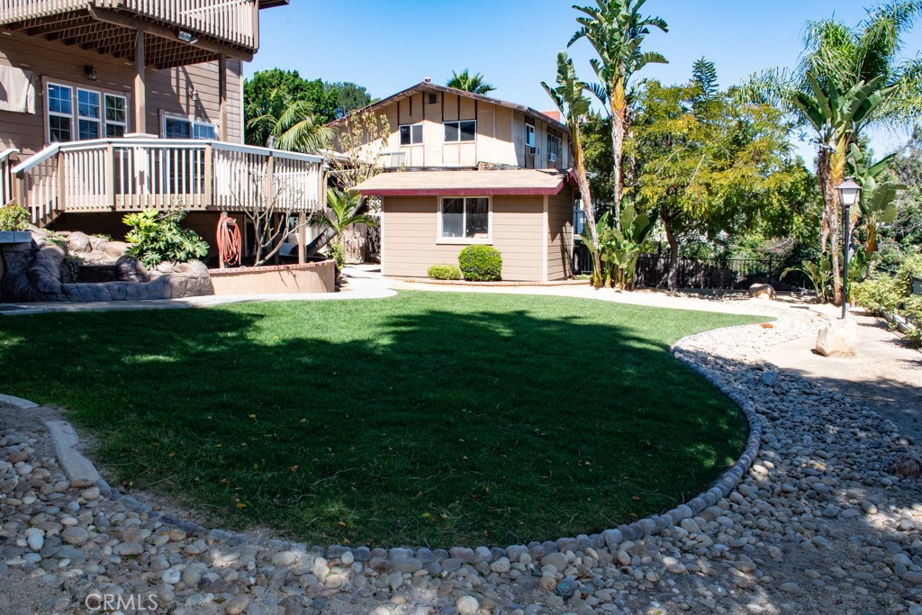 933 Eastside Road El Cajon, CA 92020 - Photo 38 of 70 a view of a white house with a big yard and potted plants