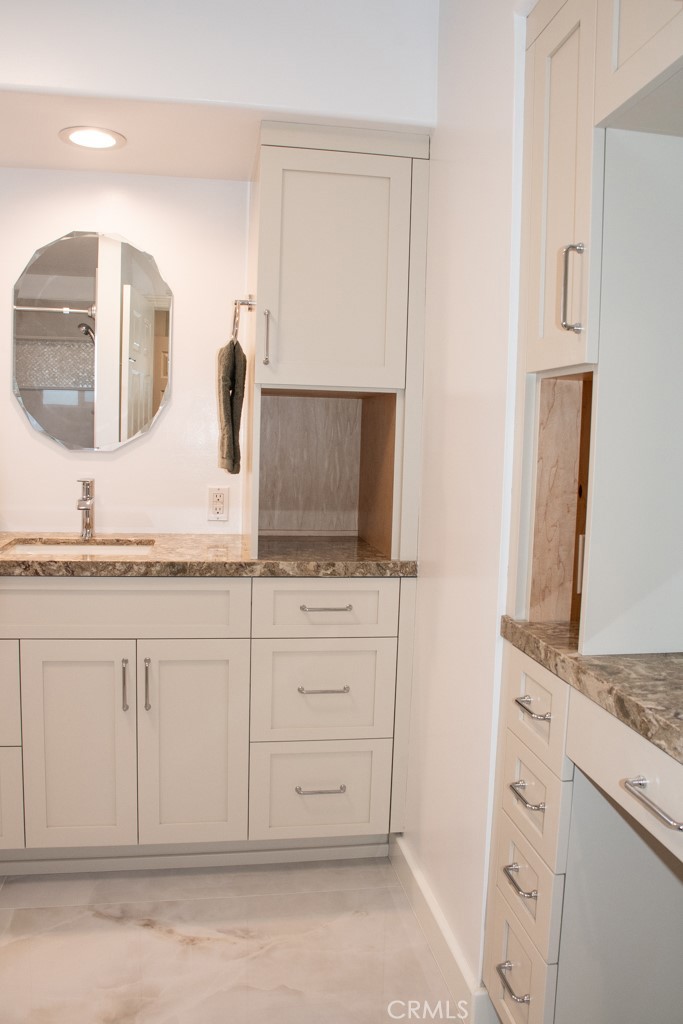 933 Eastside Road El Cajon, CA 92020 - Photo 55 of 70 a bathroom with a sink and a mirror