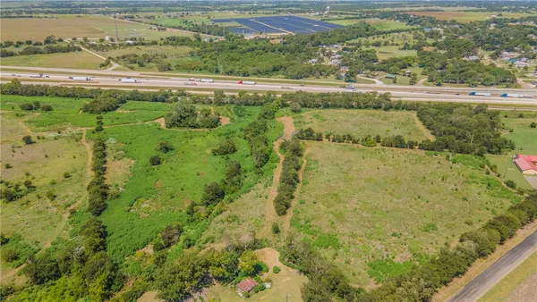 a view of a lake with a field of the side
