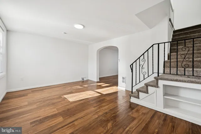 a view of entryway and hall with wooden floor