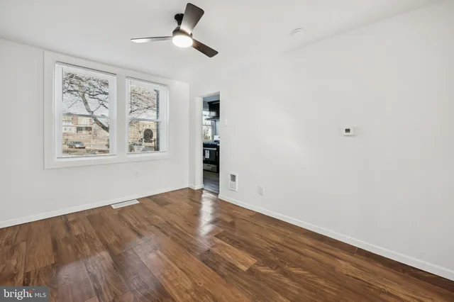 wooden floor in an empty room with a window