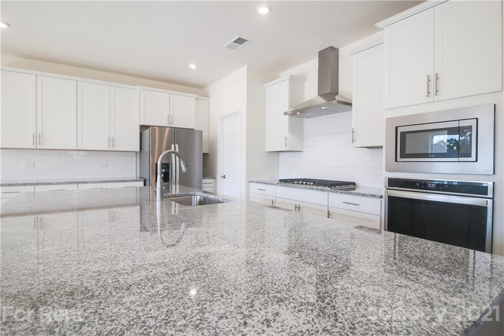 3005 Patchwork Court Fort Mill, SC 29708 - Photo 16 of 38 a kitchen with stainless steel appliances granite countertop a sink stove and refrigerator