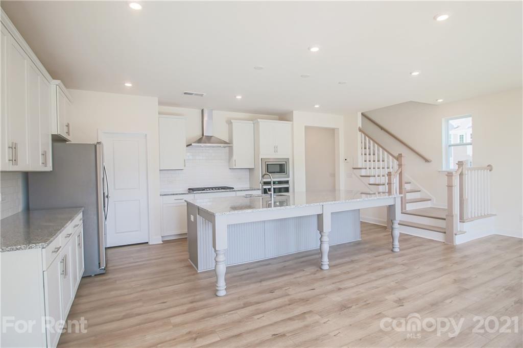 3005 Patchwork Court Fort Mill, SC 29708 - Photo 19 of 38 a kitchen with white cabinets and stainless steel appliances