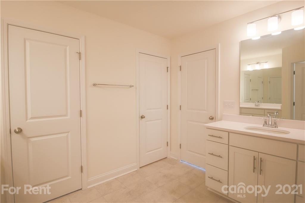 3005 Patchwork Court Fort Mill, SC 29708 - Photo 25 of 38 a bathroom with a double vanity sink and mirror