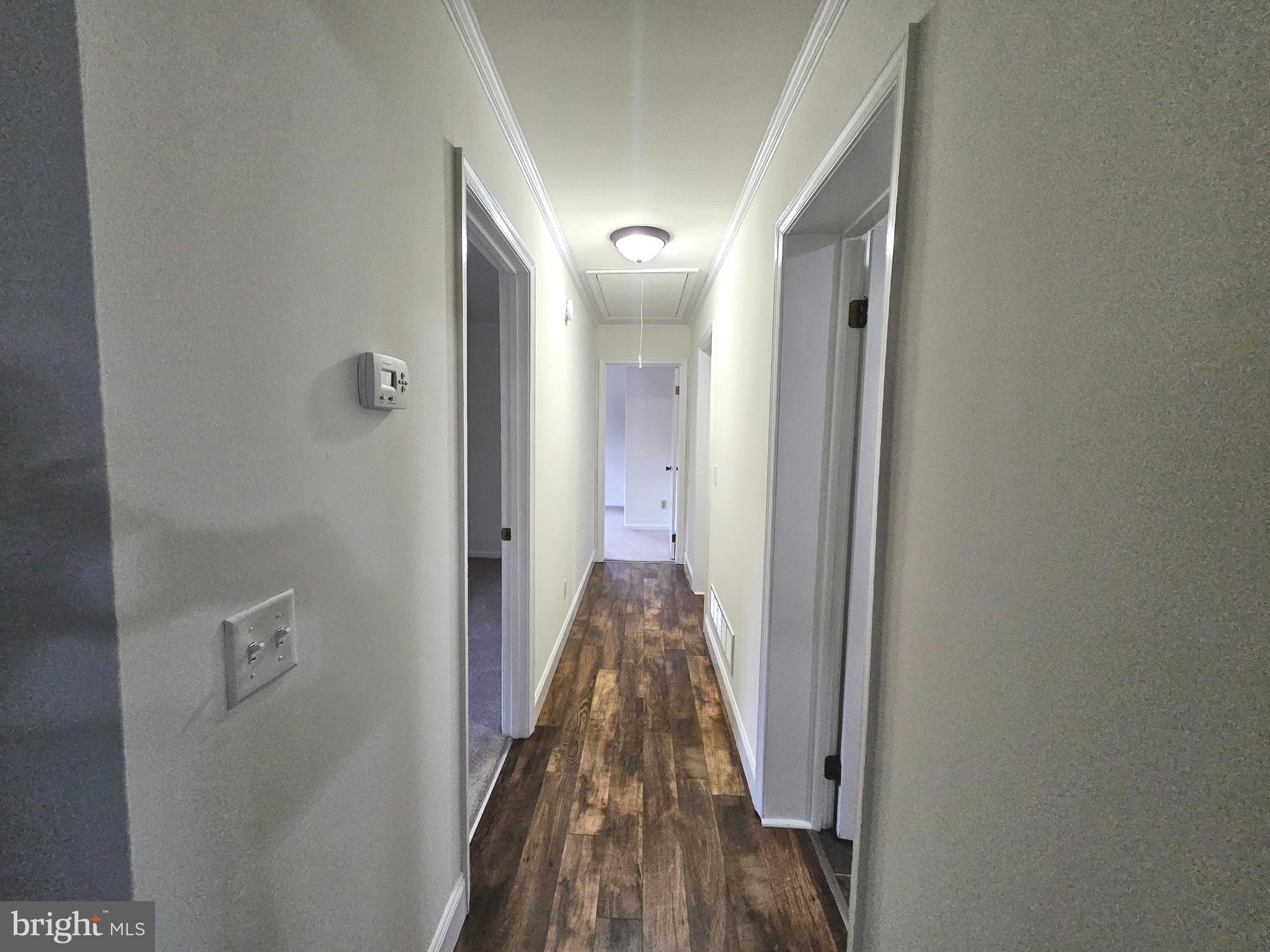 873 Skeeter Neck Road Frederica, DE 19946 - Photo 12 of 34 a view of a hallway with wooden floor and staircase